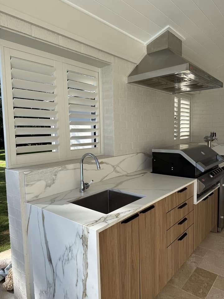 An outdoor kitchen with stone benchtop built by Fabrite Kitchens