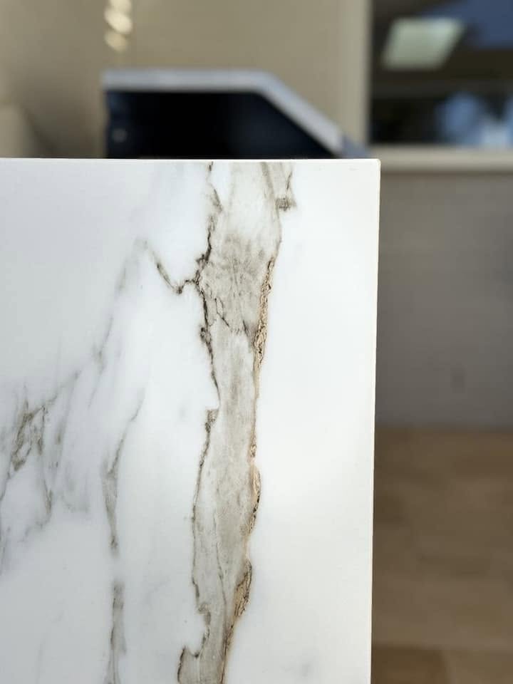 A close-up of a calacatta-look stone benchtop slab fabricated by Fabrite Kitchens